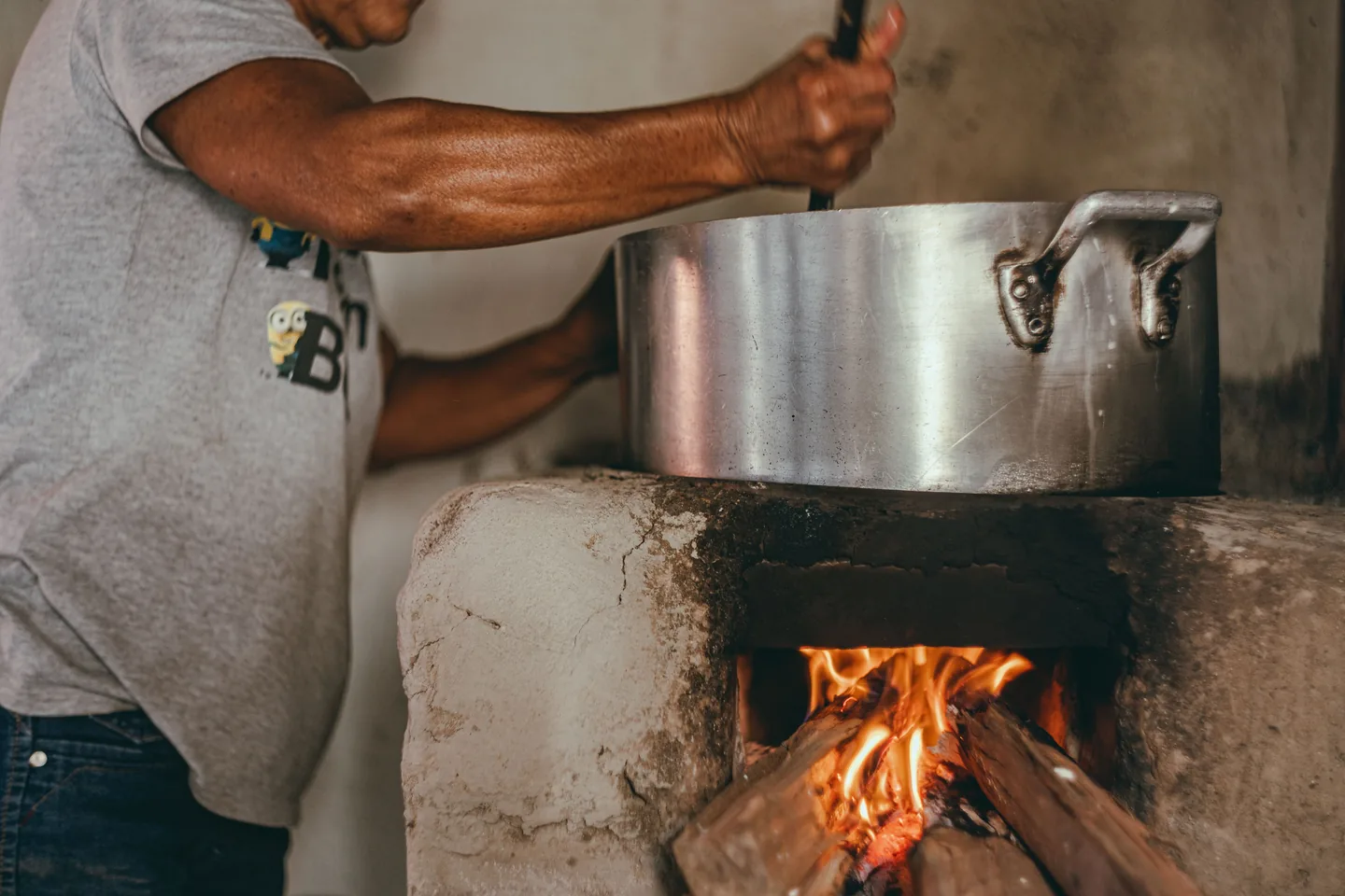 A pot cooking over an open wood fire