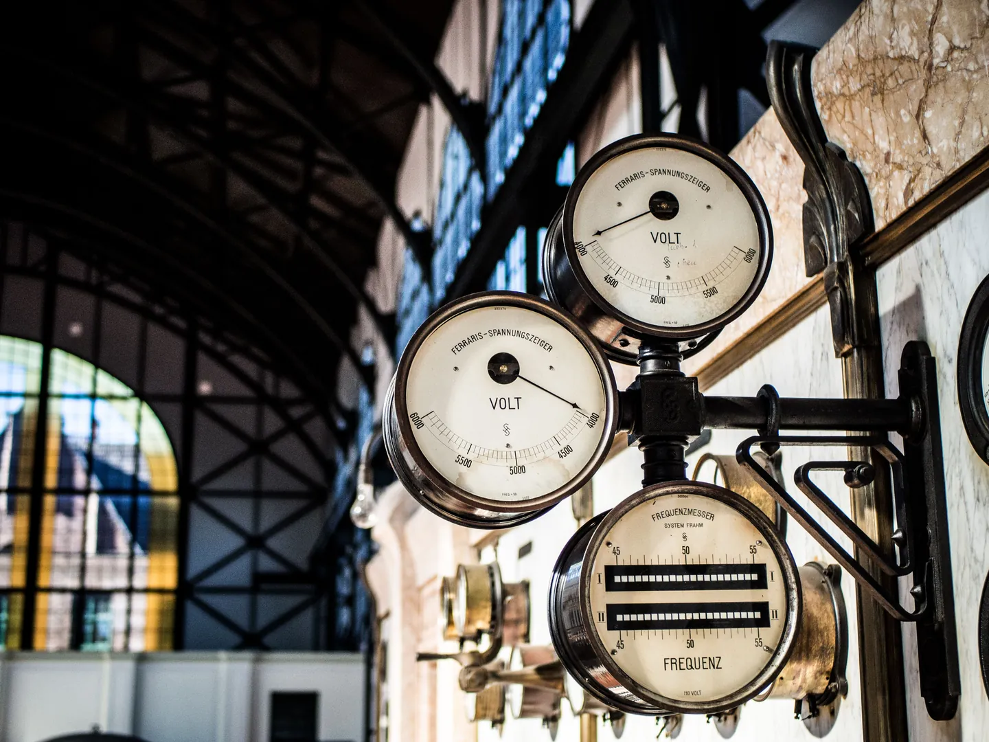Large analogue measuring dials mounted in an industrial hall