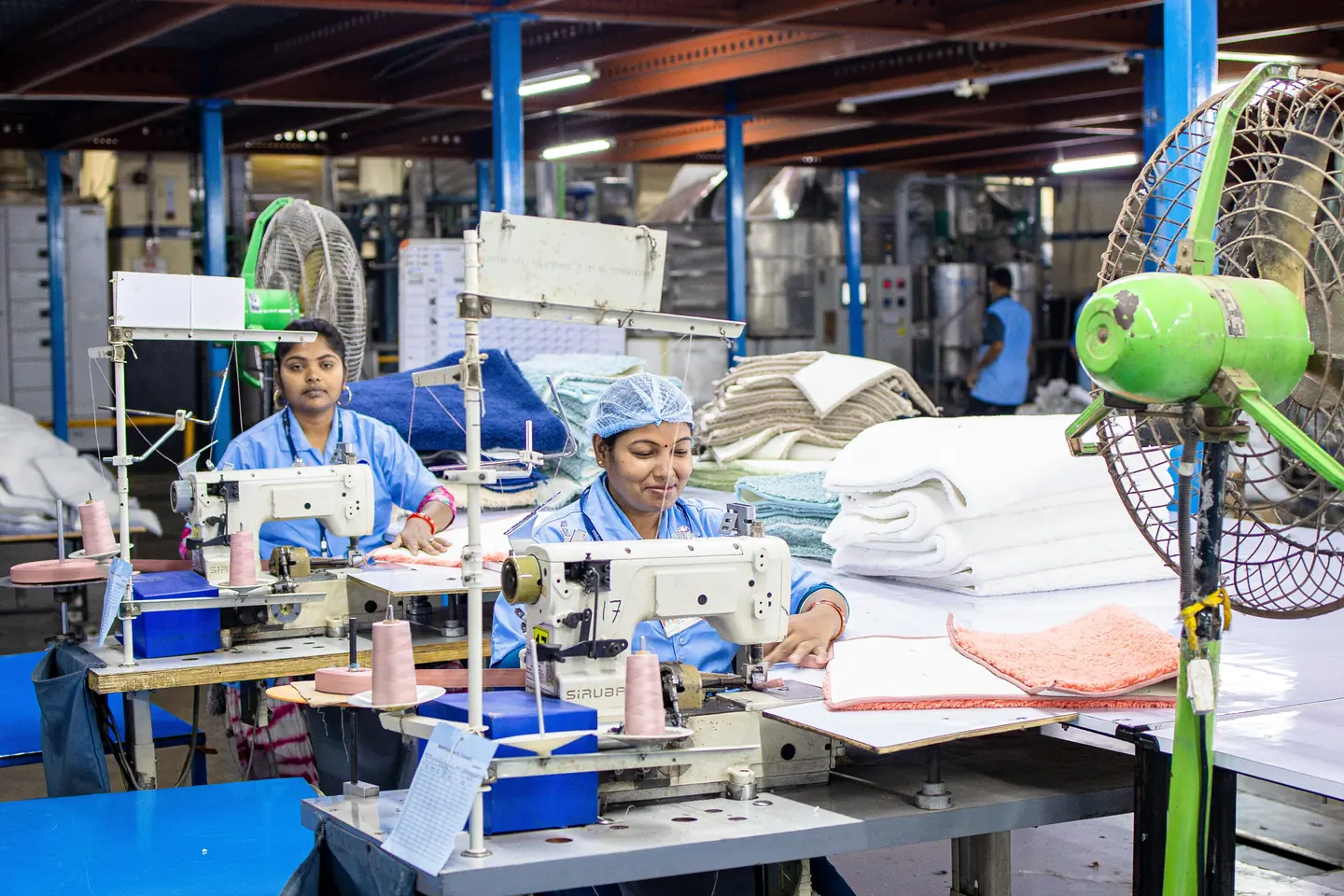 Workers at the machines on the floor of an Indian textile factory