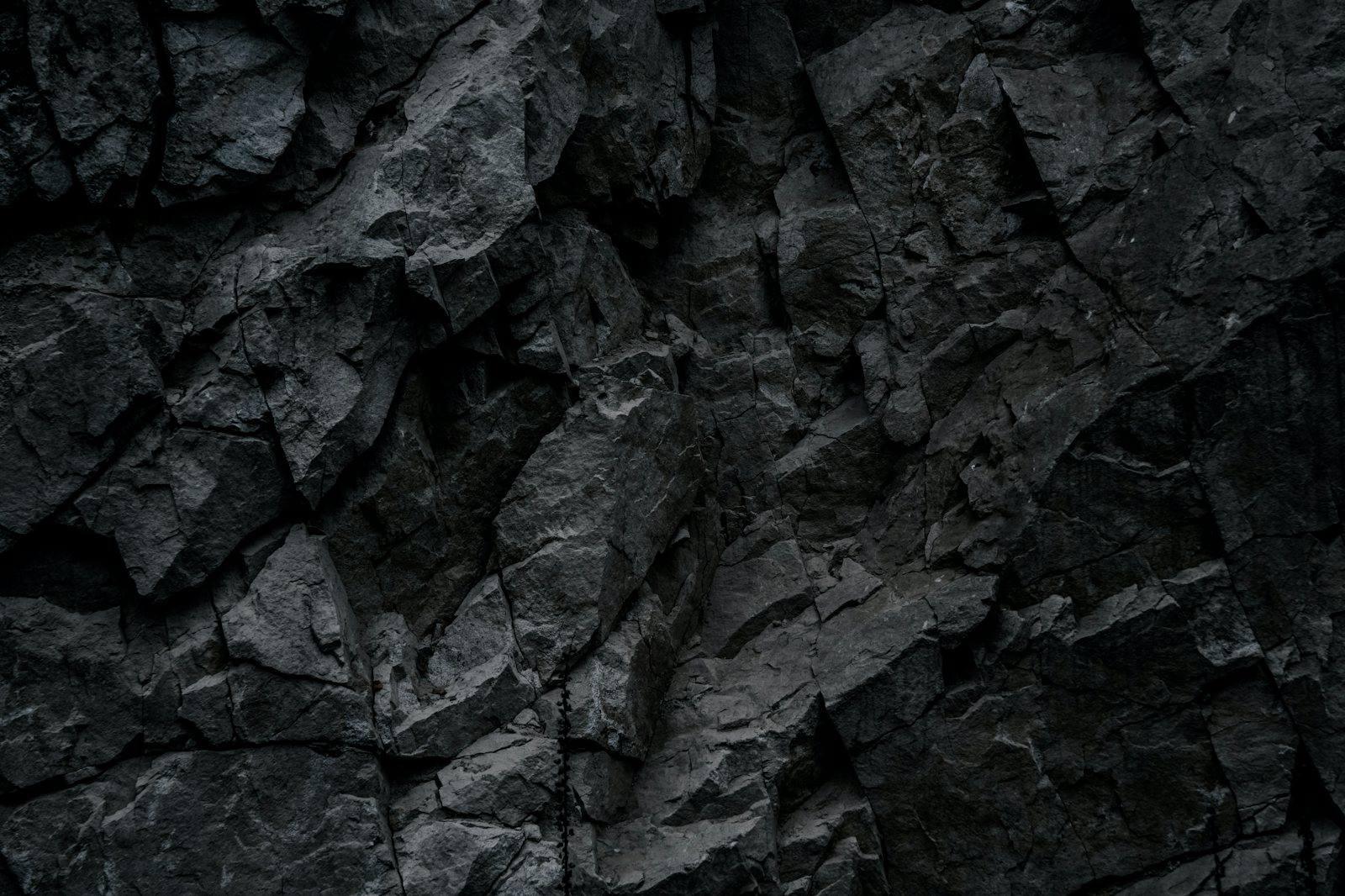 Close detail of fractured black carbon-rich rock