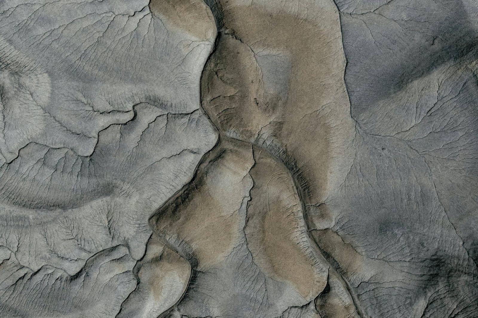 Aerial view of eroded terrain carved by dry riverbeds